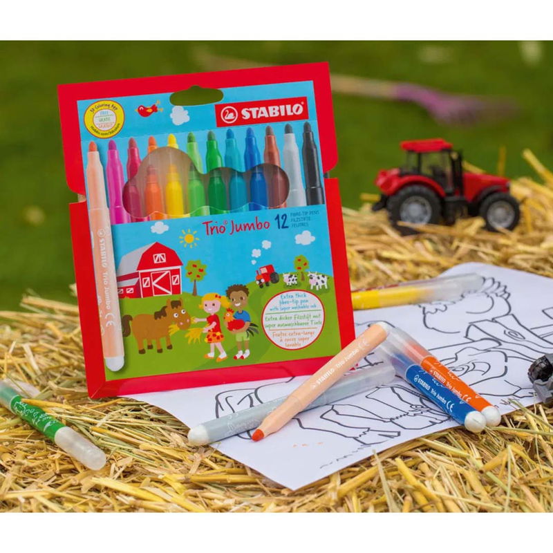 Inspirerande bild av STABILO Trio Jumbo tuschpennor 12-pack i förpackning på höbal bredvid ritpapper