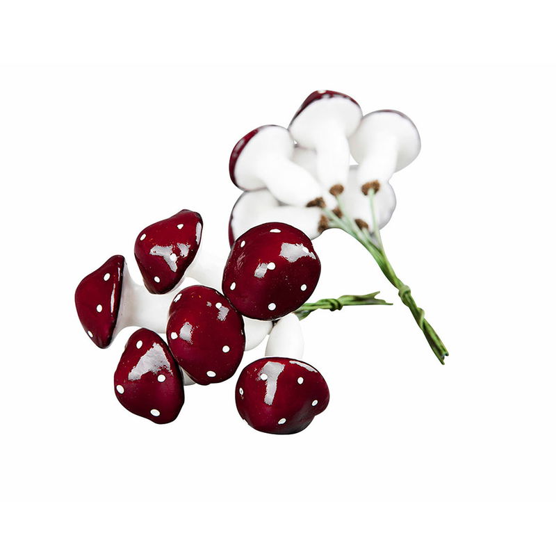 Röda flugsvampar med vita prickar på böjbar ståltråd