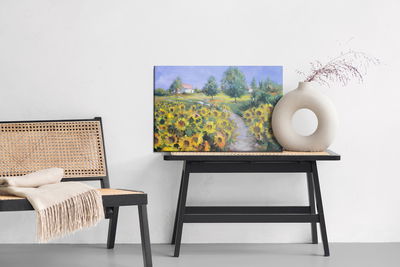 Ljuddämpande tavla - A landscape with sunflowers