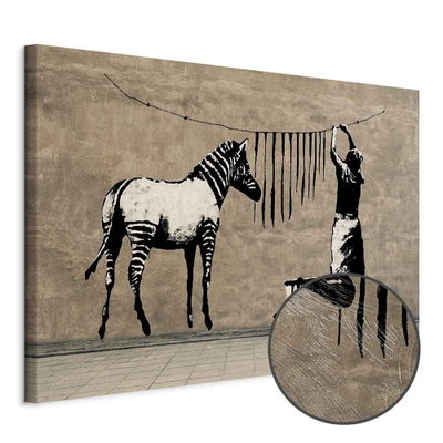 Schuin productaanzicht van Banksy washing zebra on. Het motief loopt door over de randen van het canvas. Een ronde detailopname toont het reliëf van het geloppervlak.
