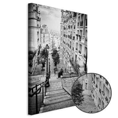 Schuin productaanzicht van Parisian suburb. Het motief loopt door over de randen van het canvas. Een ronde detailopname toont het reliëf van het geloppervlak.