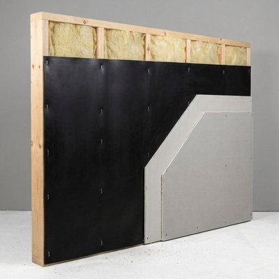 SilentDirect MLV installed in a wall section with wooden studs for soundproofing a room