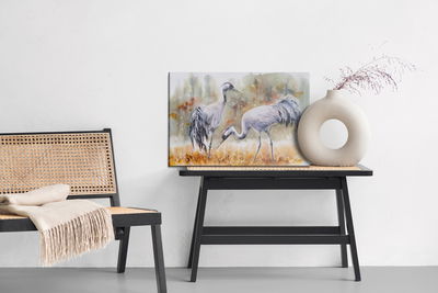 Ljuddämpande tavla - Cranes on field