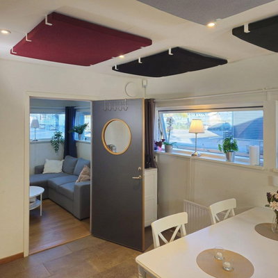 Eriväriset kattopaneelit, jotka on asennettu kattoon akustiikan parantamiseksi