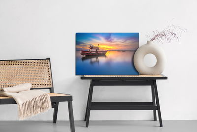 Ljuddämpande tavla - Boat at sunset