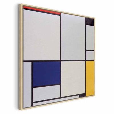 Piet mondrian tableau i – naturfärgad ram. Svarta linjer delar in vita fält med blå och gula partier i en geometrisk komposition med små röda accenter.