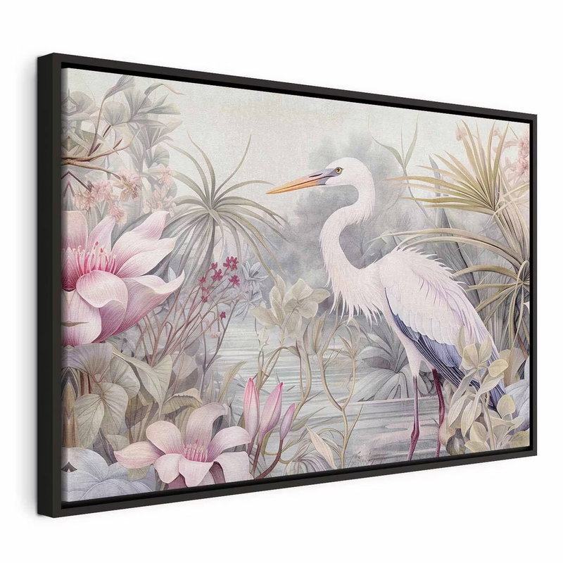 Heron wading in a pond – svart ram. En vit, långbent häger står i vatten bland rosa blommor, grågröna blad och ljusa tropiska växter.