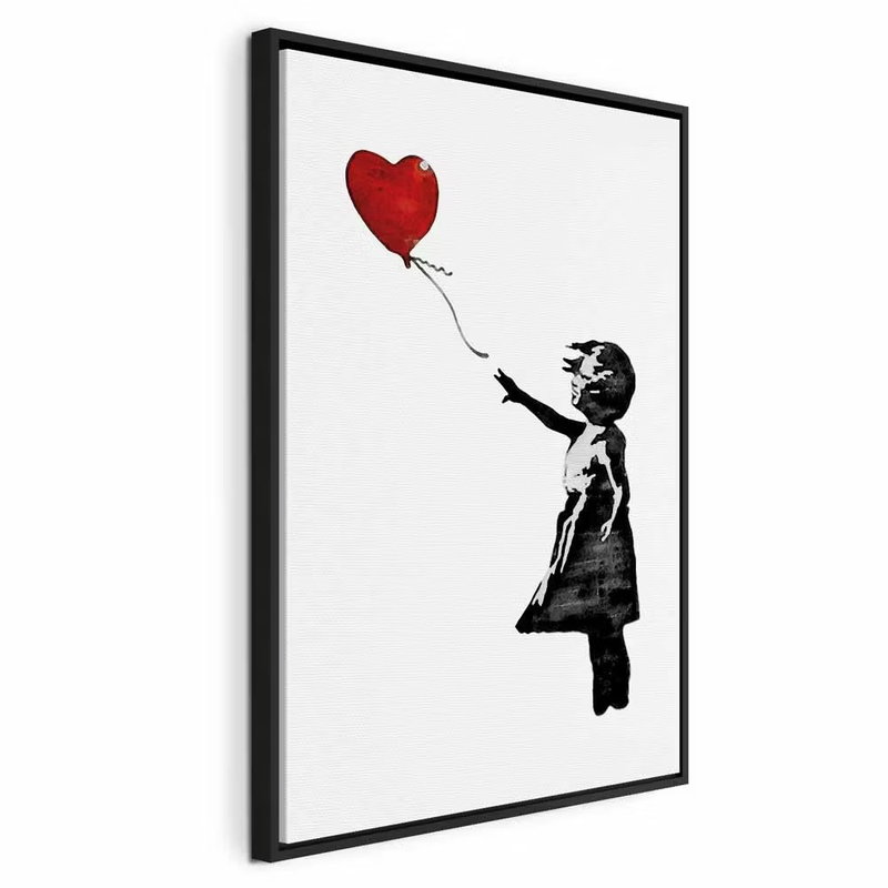 Banksy girl with balloon – svart ram. En liten svart flicksilhuett sträcker armen mot en röd hjärtformad ballong på vit botten.
