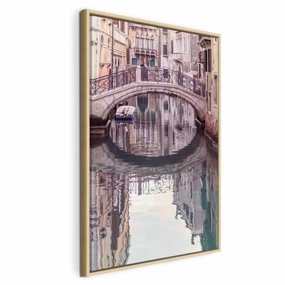 Noon in venice vertical – naturfärgad ram. En liten stenbro och täta husfasader speglas i en lugn kanal i mjuka rosa och grå toner.