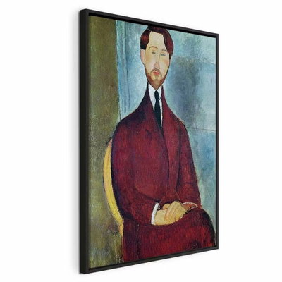 Amedeo modigliani leopold – svart ram. En långsmal man i mörkröd kavaj och slips sitter med händerna samlade framför en blågrön bakgrund.