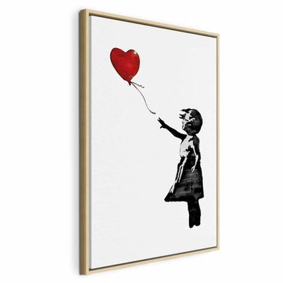 Banksy girl with balloon – naturfärgad ram. En liten svart flicksilhuett sträcker armen mot en röd hjärtformad ballong på vit botten.