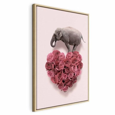 Elephant lover elephant amid – naturfärgad ram. En liten grå elefant balanserar över ett hjärta av täta rosa rosor mot en ljusrosa bakgrund.