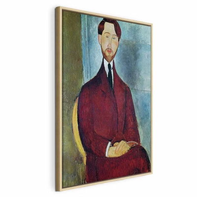 Amedeo modigliani leopold – naturfärgad ram. En långsmal man i mörkröd kavaj och slips sitter med händerna samlade framför en blågrön bakgrund.