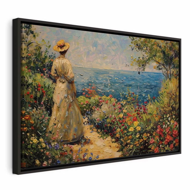Nostalgic impression a – svart ram. En figur i ljusa kläder står bland färgrika blommor och blickar mot blått vatten.
