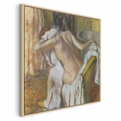 Edgar degas woman drying – naturfärgad ram. En naken kvinna böjer huvudet över en ljus handduk i en interiör med varma ockra- och bruntoner.