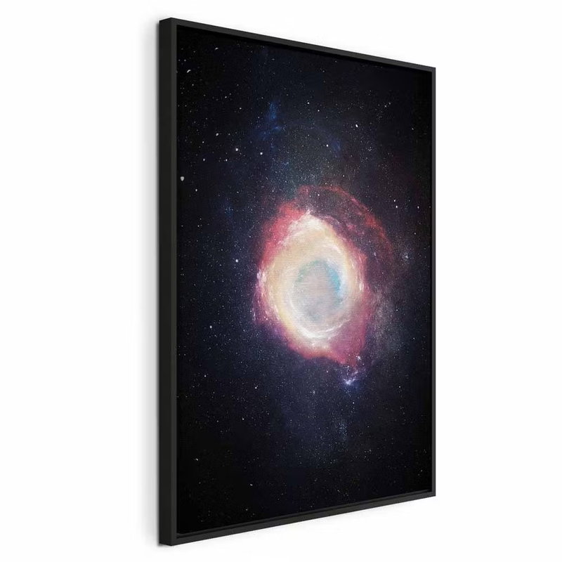 Galactic explosion vertical – svart ram. En ringformad galax glöder i vitt, gult och rosa bland små stjärnor på en djupblåsvart himmel.