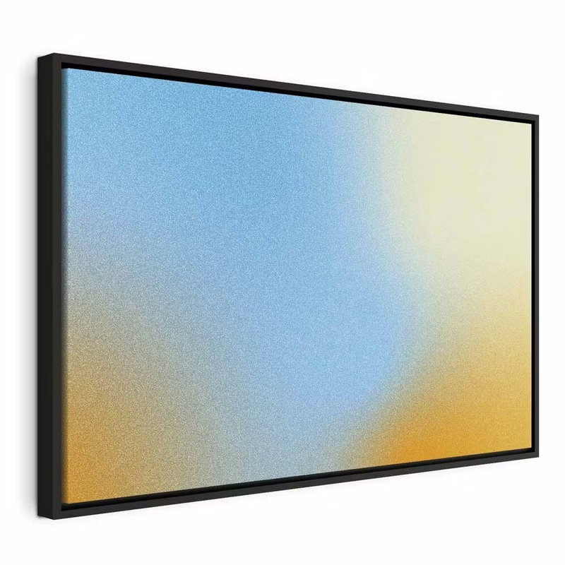 Energetic gradient gradient – svart ram. En bred, kornigt återgiven färgövergång går mellan blått, ljusgrönt, gult och varmt orange.