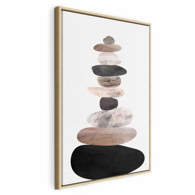 The art of balance – naturfärgad ram. Rundade stenliknande former i rosa, grått och svart ligger staplade ovanpå varandra mot en ljus botten.