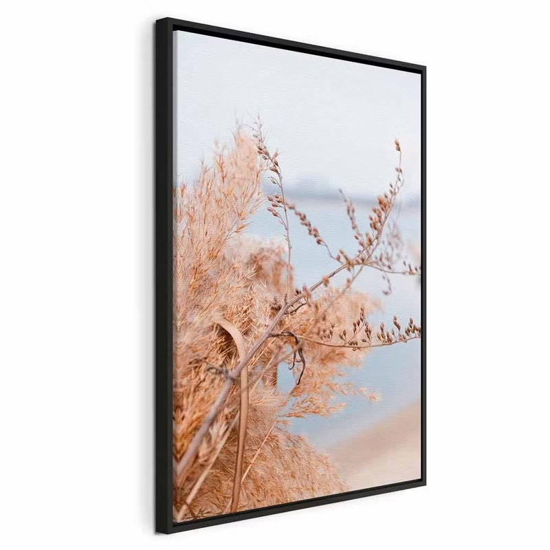 Sophisticated twigs vertical – svart ram. Tunna, ljust orange kvistar och blad står framför ett mjukt blågrått vattenlandskap.