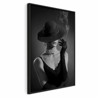 Black elegance vertical – svart ram. En kvinna i mörk hatt, handskar och pärlhalsband håller en cigarett med en liten rökstrimma mot svart.