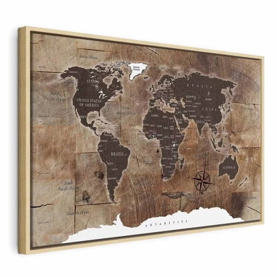World map wooden mosaic – naturfärgad ram. En mörkbrun världskarta med ljusa landgränser och en kompassros ligger över en sliten beige och brun, texturerad bakgrund.