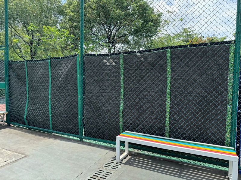 SilentDirect Sound Barrier rear side mounted on tennis court fencing.