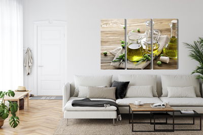 Ljuddämpande tavla - Olive oil with green olives