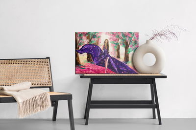 Ljuddämpande tavla - A woman among spring flowers