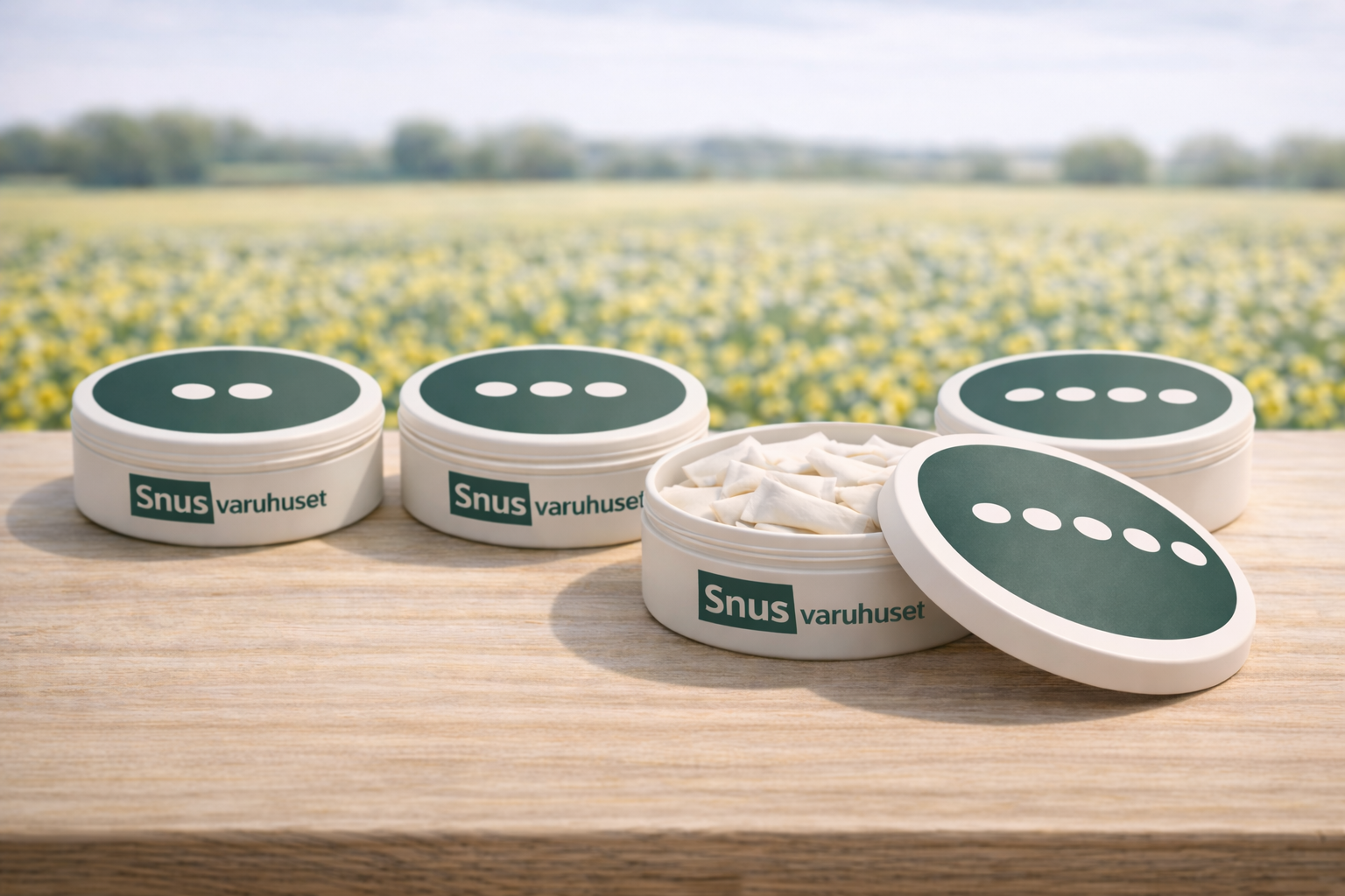 Bild med fyra snusdosor som har styrkan visualiserd med prickar/pluppar på locken